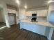 Modern kitchen island with stainless steel appliances and bright white cabinets at 11844 Ayshire Dr, Middlesex, NC 27557