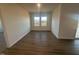 Spacious living room with wood flooring and a large window providing plenty of natural light at 11844 Ayshire Dr, Middlesex, NC 27557