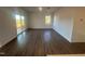 Bright living room with wood flooring and a sliding glass door leading to the backyard at 11844 Ayshire Dr, Middlesex, NC 27557