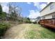 Expansive backyard with green grass and a well-maintained deck, perfect for outdoor activities at 122 Banyon Tree Ln, Cary, NC 27513