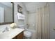 Well-lit bathroom featuring a shower-tub combo, vanity, and framed mirror at 122 Banyon Tree Ln, Cary, NC 27513