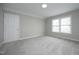 Cozy bedroom with neutral walls, carpet flooring and natural light from double windows at 122 Banyon Tree Ln, Cary, NC 27513