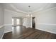 Dining room with hardwood floors leading into the living room and kitchen at 122 Banyon Tree Ln, Cary, NC 27513