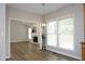 Open dining room featuring hardwood floors, a modern chandelier, and natural lighting at 122 Banyon Tree Ln, Cary, NC 27513