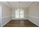 Dining room with hardwood floors, tray ceiling, decorative molding and natural light at 122 Banyon Tree Ln, Cary, NC 27513