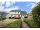 Rear exterior showcasing well-maintained backyard, deck, and lush landscaping at 122 Banyon Tree Ln, Cary, NC 27513