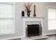 Traditional fireplace featuring white marble, ornate metalwork, and decor at 122 Banyon Tree Ln, Cary, NC 27513