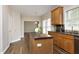 Well-lit kitchen featuring custom wood cabinets, modern appliances, and granite countertops at 122 Banyon Tree Ln, Cary, NC 27513