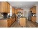 Spacious kitchen with wooden cabinets, granite countertops, and stainless steel appliances at 122 Banyon Tree Ln, Cary, NC 27513