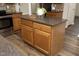 Kitchen island featuring barstool seating, granite countertops, and custom wood cabinets at 122 Banyon Tree Ln, Cary, NC 27513