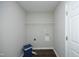Utility laundry room featuring vinyl flooring and a wire shelf at 122 Banyon Tree Ln, Cary, NC 27513