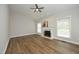 Bright living room featuring hardwood floors, modern decor, and a traditional fireplace at 122 Banyon Tree Ln, Cary, NC 27513