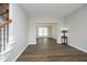 Living room with hardwood floors leading into a dining room with a tray ceiling at 122 Banyon Tree Ln, Cary, NC 27513