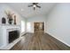 Spacious living room featuring hardwood floors, a ceiling fan, and a traditional fireplace at 122 Banyon Tree Ln, Cary, NC 27513