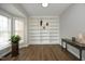 Home office features a custom-built shelving unit, modern desk, and natural lighting at 122 Banyon Tree Ln, Cary, NC 27513