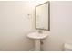 Bathroom with a pedestal sink, framed mirror, and modern fixtures at 1225 Barreto Drive Dr, Wendell, NC 27591