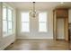 Bright dining area with hardwood floors, large windows and a modern chandelier at 1225 Barreto Drive Dr, Wendell, NC 27591