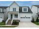 Charming two-story home featuring white siding, a welcoming front porch, and an attached two-car garage at 1225 Barreto Drive Dr, Wendell, NC 27591