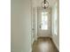 Bright foyer with hardwood floors, modern lighting, and a glass-paneled front door and sidelight at 1225 Barreto Drive Dr, Wendell, NC 27591