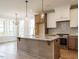 Kitchen featuring island with granite countertop, stainless appliances, and open dining area at 1225 Barreto Drive Dr, Wendell, NC 27591