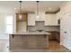 Spacious kitchen with a large island, stainless steel appliances, and designer lighting at 1225 Barreto Drive Dr, Wendell, NC 27591
