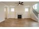 Spacious living room featuring a fireplace, built-in cabinets, luxury vinyl plank flooring, and staircase access at 1225 Barreto Drive Dr, Wendell, NC 27591