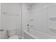 Clean white bathroom with a tub and shower, showcasing a functional design at 140 Baker Farm Dr, Youngsville, NC 27596