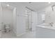 Bright bathroom with a glass enclosed shower, tile flooring, toilet, and white cabinets with double sinks at 140 Baker Farm Dr, Youngsville, NC 27596