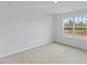 A bedroom with neutral carpet, white walls, and a window with a view at 140 Baker Farm Dr, Youngsville, NC 27596