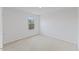 A bedroom with neutral carpet, white walls, and a window with a view at 140 Baker Farm Dr, Youngsville, NC 27596