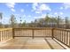 Wooden deck offering a serene outdoor space with views of the wooded property at 140 Baker Farm Dr, Youngsville, NC 27596