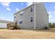 Two-story home featuring gray siding, a wooden deck, and a spacious backyard at 140 Baker Farm Dr, Youngsville, NC 27596