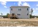 Two-story home featuring gray siding, a wooden deck, and a spacious backyard at 140 Baker Farm Dr, Youngsville, NC 27596