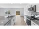 Bright kitchen with granite countertops, stainless steel appliances, and access to the back deck at 140 Baker Farm Dr, Youngsville, NC 27596