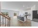 Open concept kitchen featuring a large island, white cabinets, and stainless steel appliances at 140 Baker Farm Dr, Youngsville, NC 27596