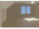 Bedroom with wood floors and a large window at 148 Mohawk Dr, Louisburg, NC 27549