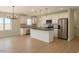 Bright, modern kitchen with stainless steel appliances, central island, pendant lighting, and sleek white cabinets at 148 Mohawk Dr, Louisburg, NC 27549