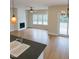 Open-concept living room featuring a fireplace, hardwood floors, neutral paint and natural light from the large windows at 148 Mohawk Dr, Louisburg, NC 27549