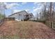 Large backyard with a view of the home's siding, deck, and surrounding trees at 1600 Frog Hollow Way, Wake Forest, NC 27587