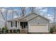 Charming single-Gathering home featuring a welcoming front porch and attached two-car garage at 1600 Frog Hollow Way, Wake Forest, NC 27587