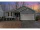 Charming single-story home with gray siding, a cozy front porch, and well-maintained landscaping at 1600 Frog Hollow Way, Wake Forest, NC 27587
