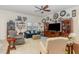 Cozy living room with comfortable seating, a ceiling fan, and a wall of clocks at 1600 Frog Hollow Way, Wake Forest, NC 27587