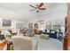 Bright living room featuring hardwood floors, large windows, and a ceiling fan at 1600 Frog Hollow Way, Wake Forest, NC 27587