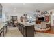 Open-concept living space with a kitchen island, dining area, and comfortable seating at 1600 Frog Hollow Way, Wake Forest, NC 27587