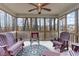 Relaxing screened porch with comfortable seating and a ceiling fan at 1600 Frog Hollow Way, Wake Forest, NC 27587