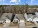 An aerial view shows a well-kept neighborhood with manicured lawns and homes backing to trees at 1713 Wrenn Rd, Durham, NC 27703