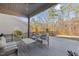 Relaxing back deck with comfortable seating, hanging chair, and wooded backyard views at 1713 Wrenn Rd, Durham, NC 27703