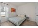 Minimalist bedroom with neutral tones, a cozy bed, and ample natural light from the window at 1713 Wrenn Rd, Durham, NC 27703