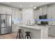Modern kitchen with stainless steel appliances, granite countertops, and an island with bar seating at 1713 Wrenn Rd, Durham, NC 27703