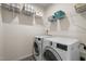 Functional laundry room with modern washer and dryer, overhead shelving, and efficient storage solutions at 1713 Wrenn Rd, Durham, NC 27703